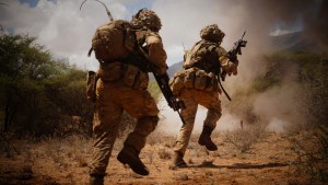 Two soldiers advancing under the cover of smoke on exercise in Kenya