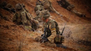 A 4 MERCIAN soldier at a forming up point as his unit prepares to assault an enemy position on exercise in Kenya