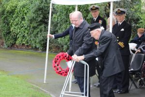 Geoff Stott prepares to lay a wreath at the Broughton House cenotaph, assisted by Broughton House chief executive Ty Platten